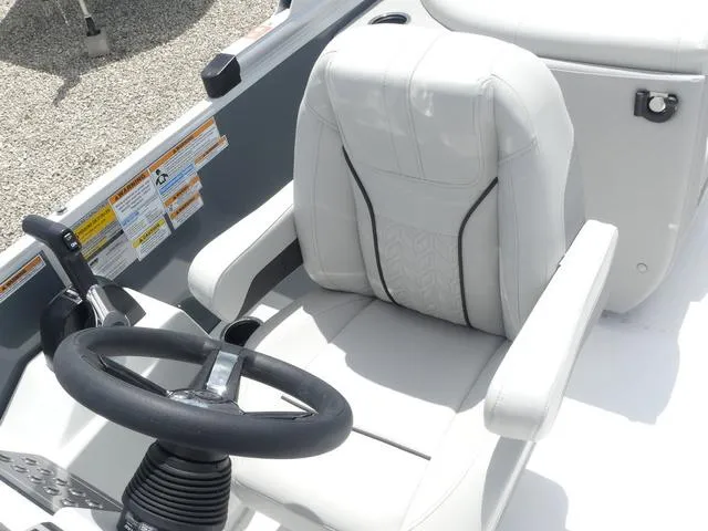 Slide: The Image of Captain's seat and steering wheel of 2025 Hurricane FunDeck 2360 RE OB boat. - 16