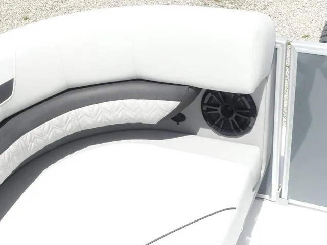 Slide: The Image of 2025 Hurricane FunDeck 2360 RE OB boat interior with white seating and speaker. - 22