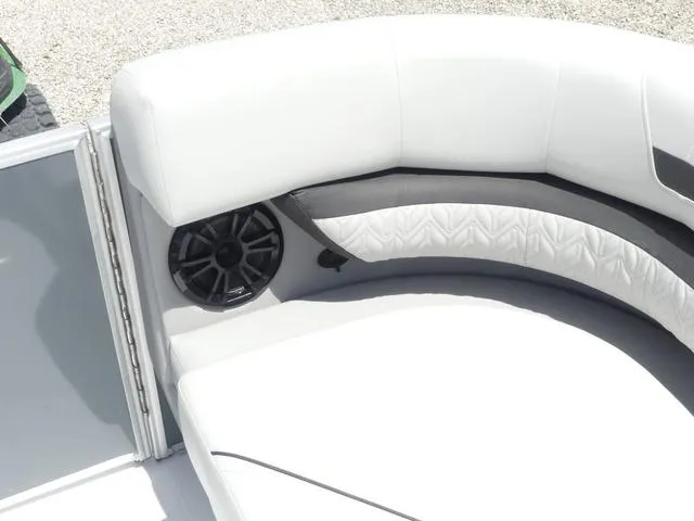 Slide: The Image of 2025 Hurricane FunDeck 2360 RE OB boat interior with white cushioned seating and speaker. - 23