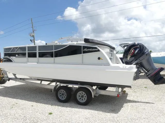 Slide: The Image of 2025 Hurricane FunDeck 2360 RE OB boat on trailer, outdoor display. - 3