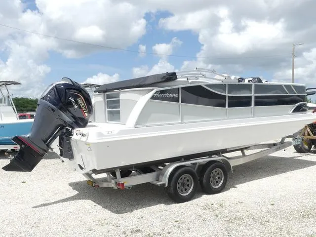 Slide: The Image of 2025 Hurricane FunDeck 2360 RE OB boat on trailer under cloudy sky. - 5