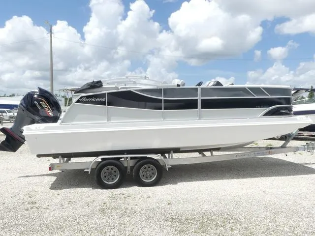Slide: The Image of 2025 Hurricane FunDeck 2360 RE OB boat on trailer under cloudy sky. - 6
