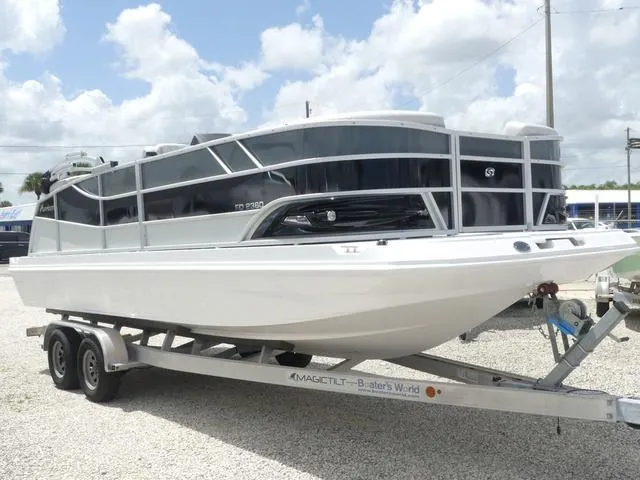 Slide: The Image of 2025 Hurricane FunDeck 2360 RE OB boat on trailer under cloudy sky. - 7
