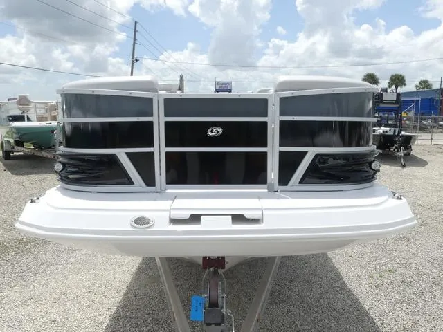 Slide: The Image of 2025 Hurricane FunDeck 2360 RE OB boat, front view, parked on gravel lot. - 8