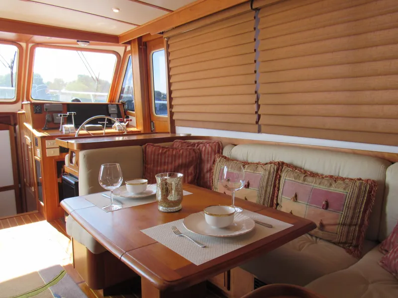 Slide: The Image of Interior of 1999 Sabreline 47 yacht with elegant dining area and cozy seating. - 11