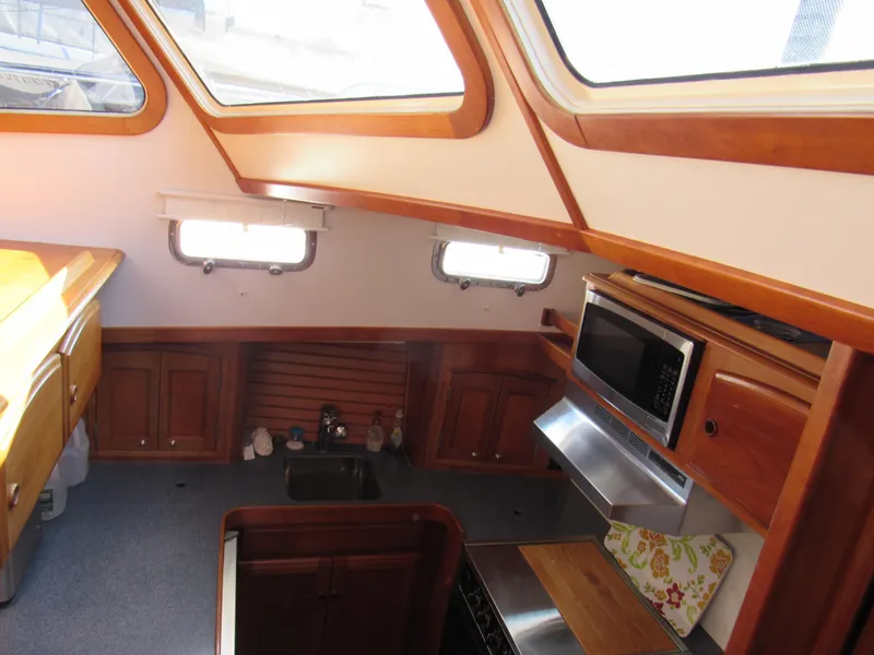 Slide: The Image of Interior of 1999 Sabre Sabreline 47 yacht kitchen with wood cabinetry and skylights. - 14