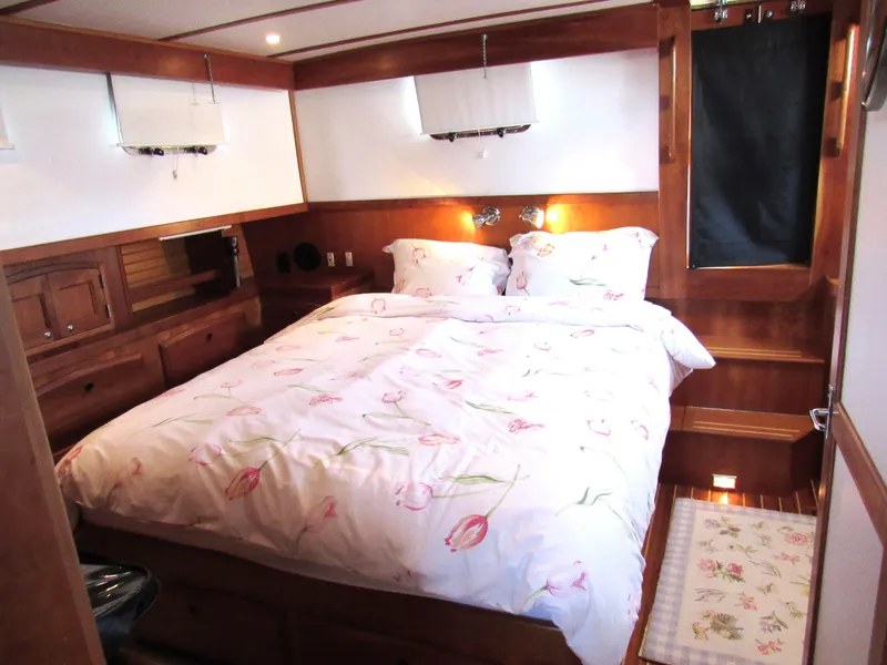 Slide: The Image of Cozy bedroom in 1999 Sabre Sabreline 47 yacht with floral bedding and wooden interior. - 16