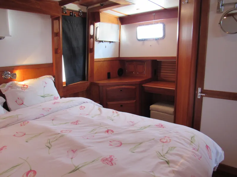 Slide: The Image of Cozy bedroom in 1999 Sabreline 47 yacht with floral bedding and wooden interior. - 17
