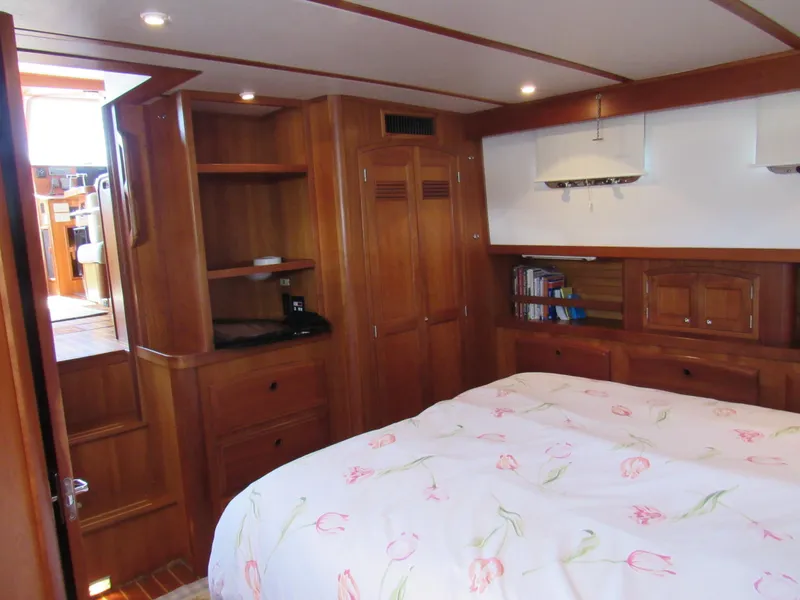 Slide: The Image of Cozy bedroom in 1999 Sabre Sabreline 47 yacht with wooden cabinetry and floral bedding. - 18