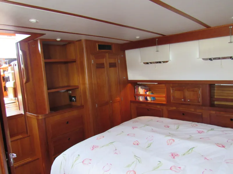 Slide: The Image of Cozy bedroom in 1999 Sabre Sabreline 47 yacht with wooden cabinetry and floral bedding. - 19