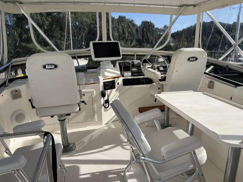 Slide: The Image of Interior of 1999 Sabreline 47 yacht with helm, seating, and navigation equipment. - 2