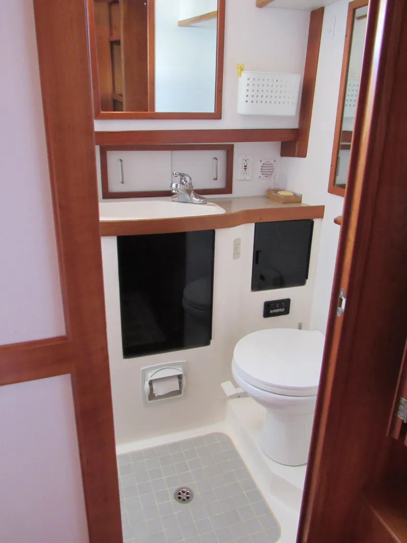 Slide: The Image of 1999 Sabre Sabreline 47 yacht bathroom with wood accents and modern fixtures. - 20
