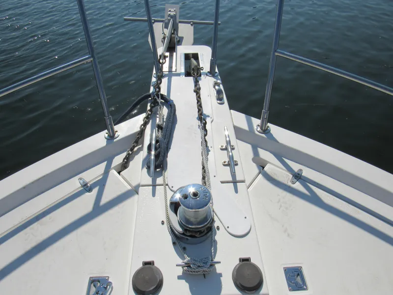 Slide: The Image of Bow of 1999 Sabreline 47 yacht with anchor chain and winch. - 3