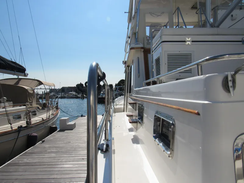 Slide: The Image of Sabreline 47 yacht docked at marina, showcasing sleek design and polished railings. - 4