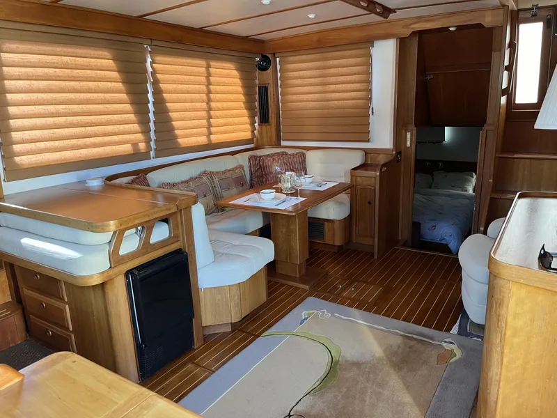 Slide: The Image of Interior of 1999 Sabre Sabreline 47 yacht with wood finish and cozy seating area. - 5