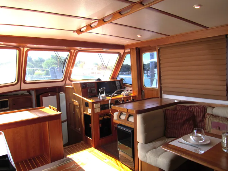 Slide: The Image of Interior of 1999 Sabreline 47 yacht with wood finish and cozy seating area. - 6