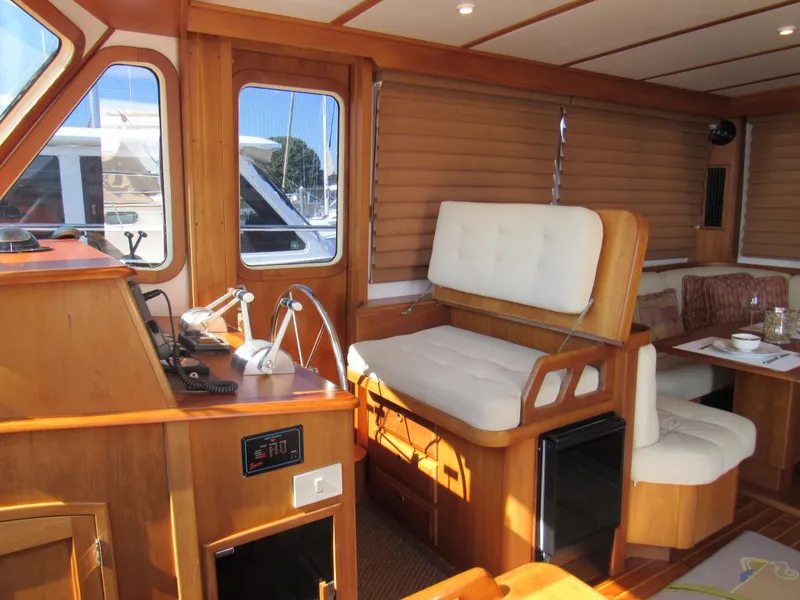 Slide: The Image of Interior of 1999 Sabreline 47 yacht with wooden finish and comfortable seating. - 7