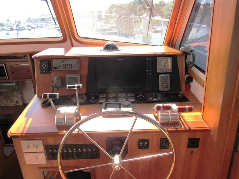 Slide: The Image of 1999 Sabre Sabreline 47 yacht helm with navigation controls and steering wheel. - 8