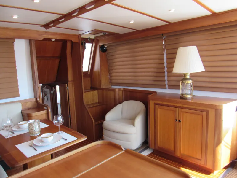 Slide: The Image of Interior of 1999 Sabre Sabreline 47 yacht with elegant wood finish and dining area. - 9