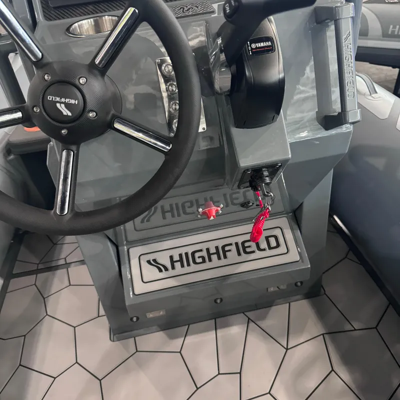 Slide: The Image of Highfield Sport 560 boat dashboard with steering wheel and controls, 2025 model. - 11