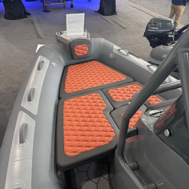 Slide: The Image of 2025 Highfield Sport 560 boat with orange cushioned seating and Yamaha motor. - 12