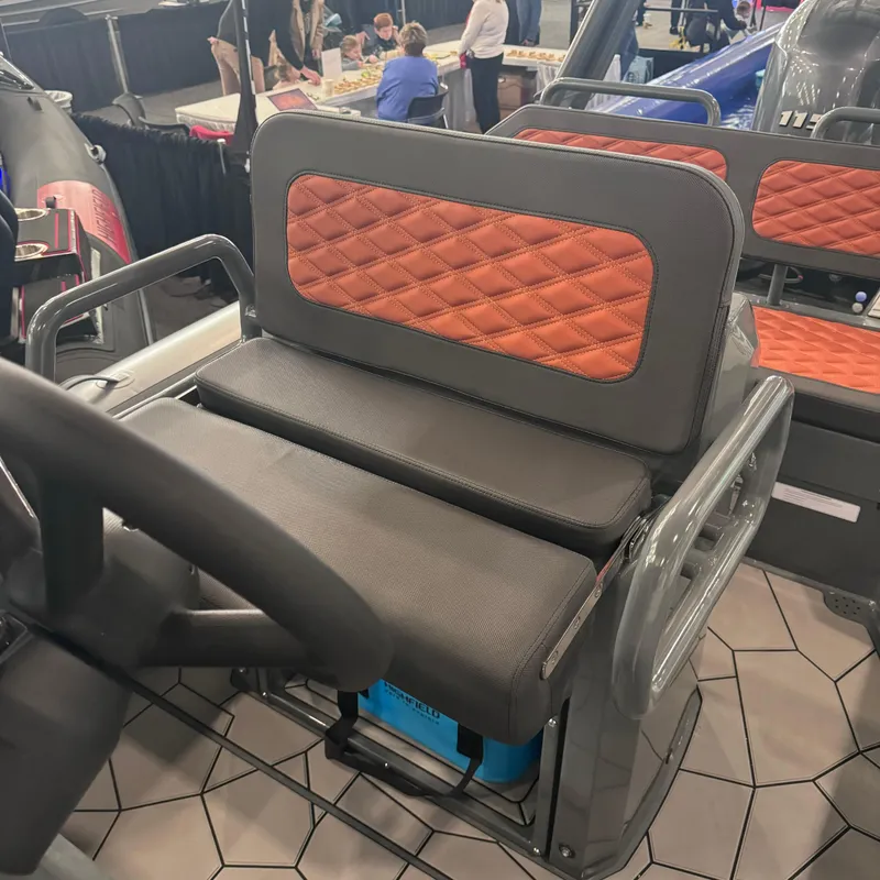 Slide: The Image of Highfield Sport 560 boat seat, 2025 model, with quilted orange and gray upholstery. - 14