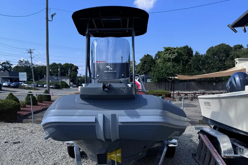 Slide: The Image of 2025 Highfield Sport 560 boat displayed outdoors on gravel lot. - 3