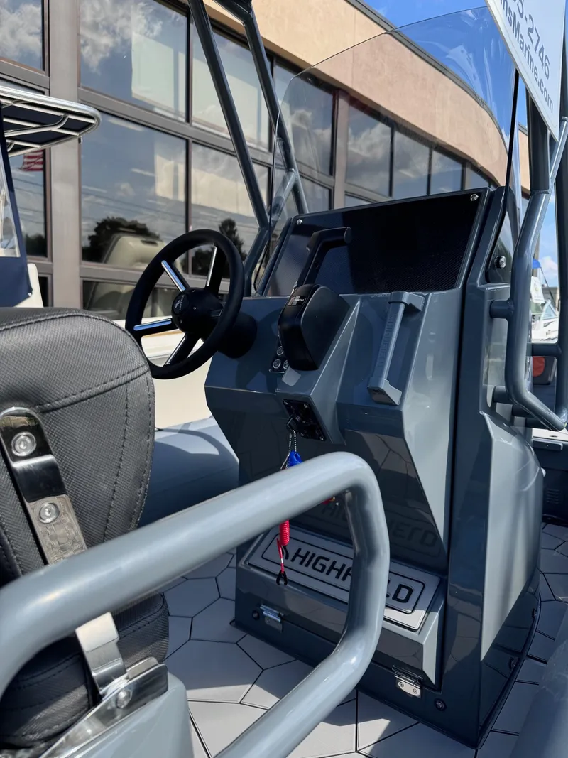 Slide: The Image of 2025 Highfield Sport 560 boat cockpit with steering wheel and controls. - 7