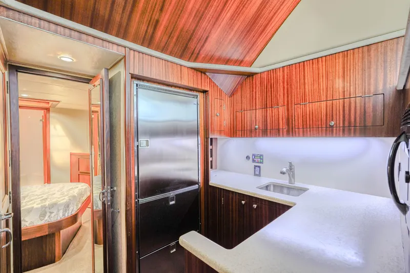 Slide: The Image of Interior of 1982 Hatteras 46 Convertible yacht kitchen with wood cabinetry and stainless steel appliances. - 16