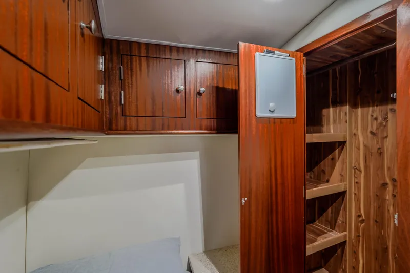 Slide: The Image of Interior cabin of 1982 Hatteras 46 Convertible with wooden cabinetry and shelving. - 18