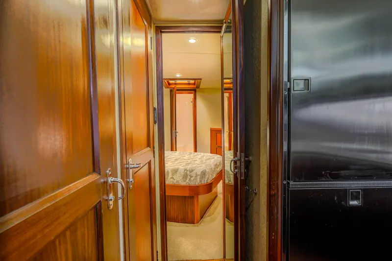 Slide: The Image of Interior of 1982 Hatteras 46 Convertible yacht, featuring wood paneling and cozy bedroom. - 19