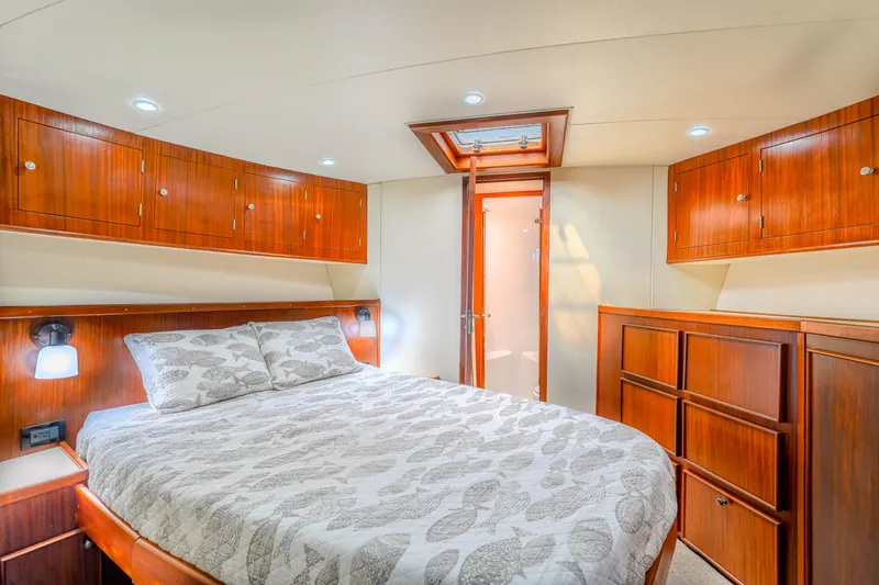 Slide: The Image of Luxurious bedroom interior of 1982 Hatteras 46 Convertible yacht with wood cabinetry. - 20