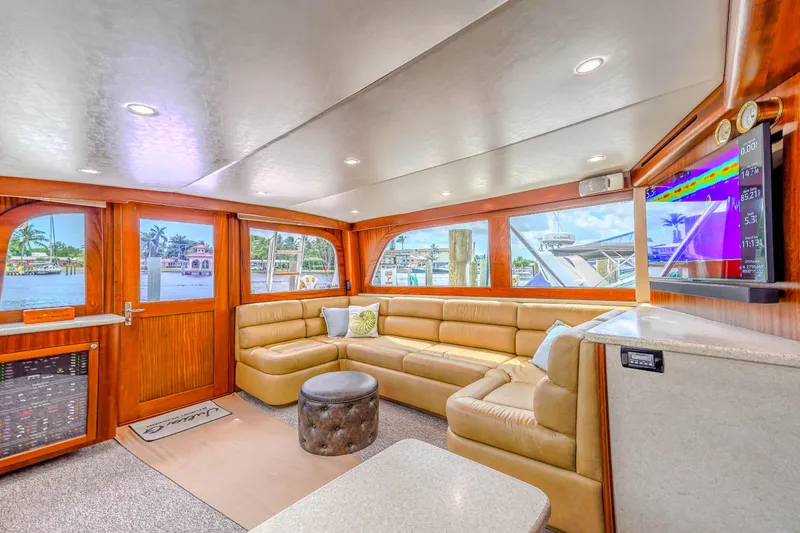 Slide: The Image of Luxurious interior of 1982 Hatteras 46 Convertible yacht with plush seating and scenic windows. - 27