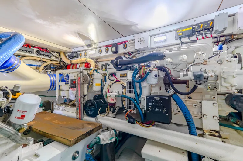 Slide: The Image of Engine room of 1982 Hatteras 46 Convertible yacht, showcasing complex machinery and wiring. - 30
