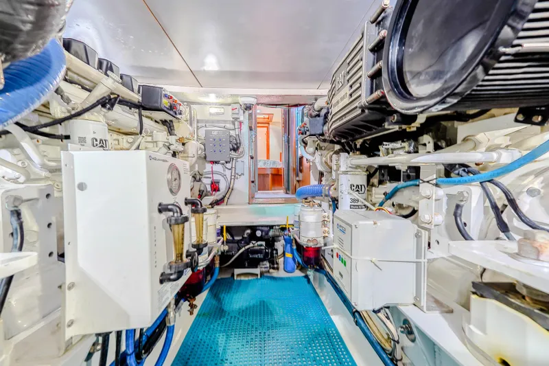 Slide: The Image of Engine room of 1982 Hatteras 46 Convertible yacht, featuring CAT machinery and equipment. - 32