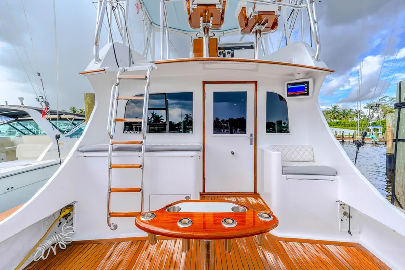 Slide: The Image of 1982 Hatteras 46 Convertible yacht with teak deck and ladder, docked at marina. - 39