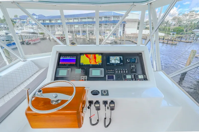 Slide: The Image of 1982 Hatteras 46 Convertible helm with navigation equipment and marina view. - 42