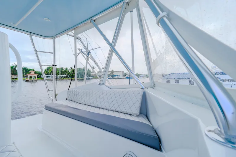 Slide: The Image of 1982 Hatteras 46 Convertible yacht interior with cushioned seating and waterfront view. - 45