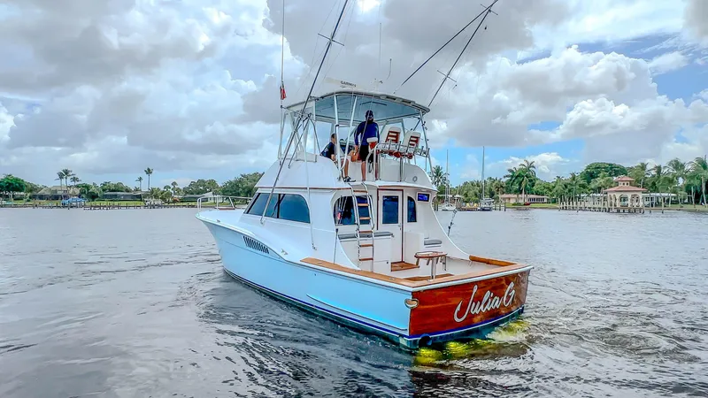 Slide: The Image of 1982 Hatteras 46 Convertible yacht on calm water under cloudy sky. - 9