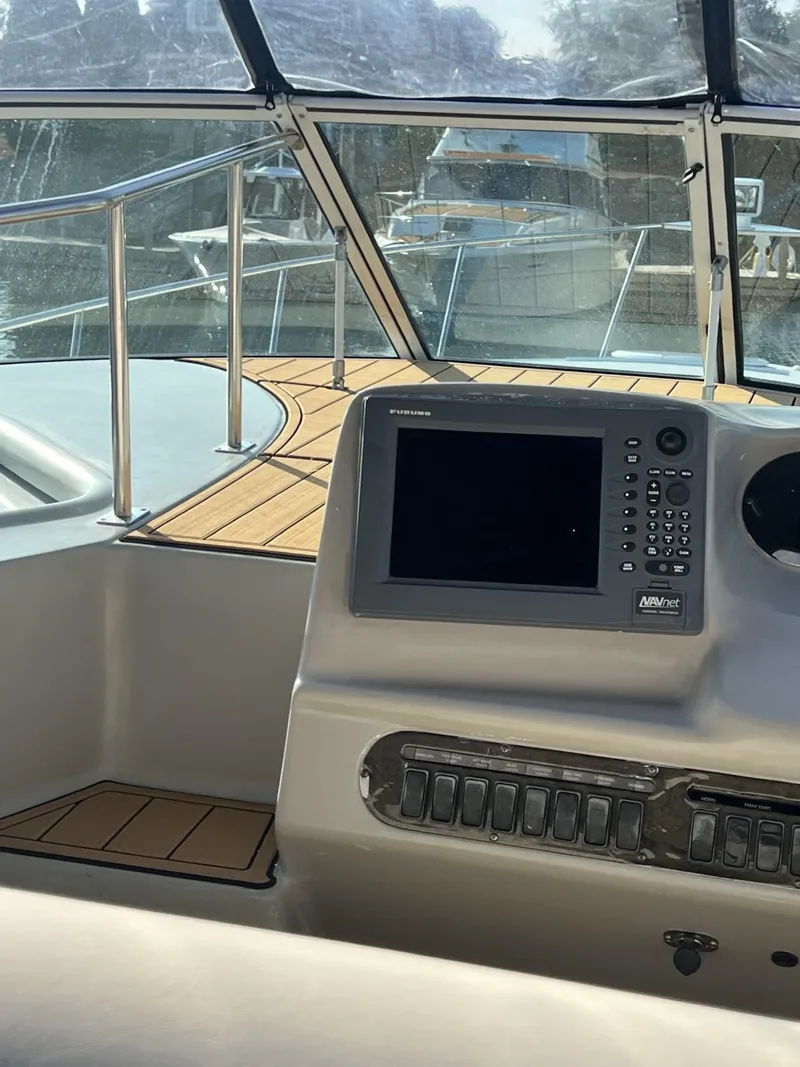 Slide: The Image of 2004 Cruisers Yachts 320 Express helm with navigation system and teak deck. - 10