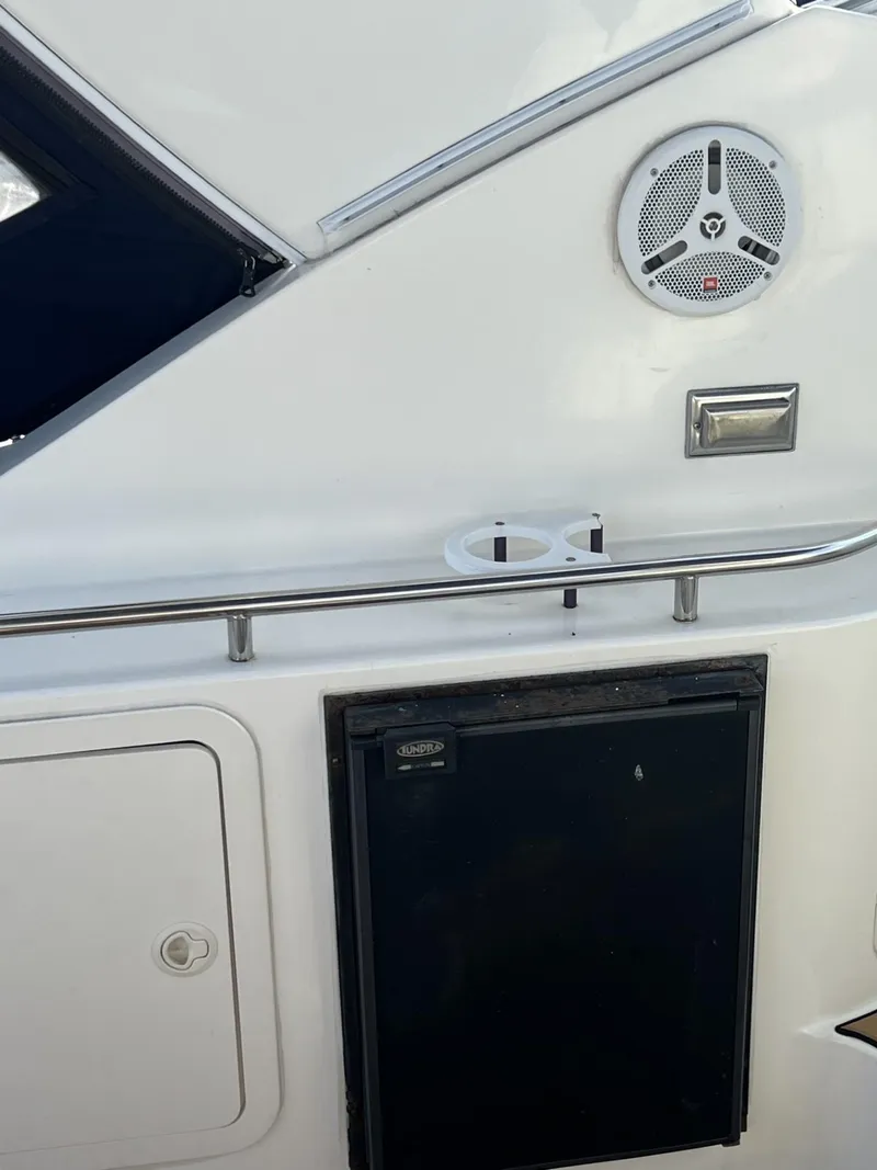 Slide: The Image of 2004 Cruisers Yachts 320 Express boat interior with speaker and storage compartments. - 11