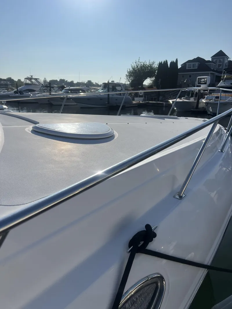 Slide: The Image of 2004 Cruisers Yachts 320 Express docked in sunny marina. - 4