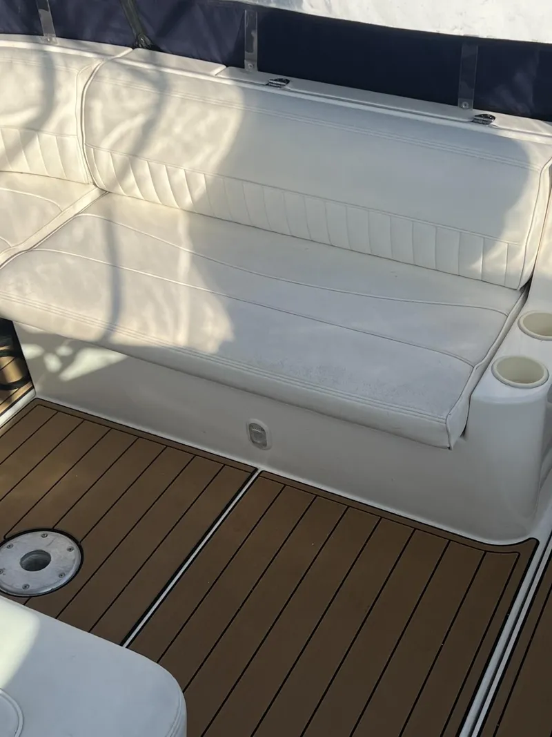 Slide: The Image of 2004 Cruisers Yachts 320 Express interior with white seating and teak flooring. - 5