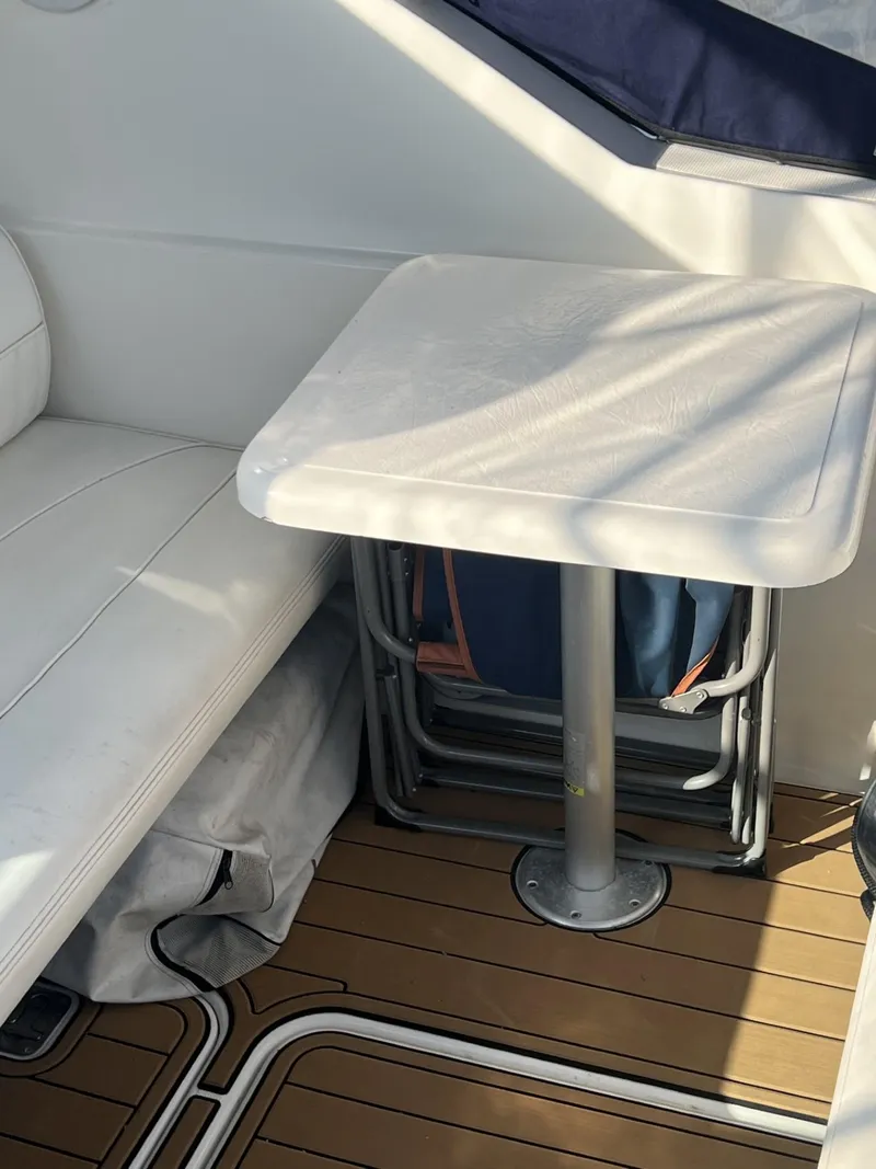 Slide: The Image of 2004 Cruisers Yachts 320 Express interior with seating and table. - 6