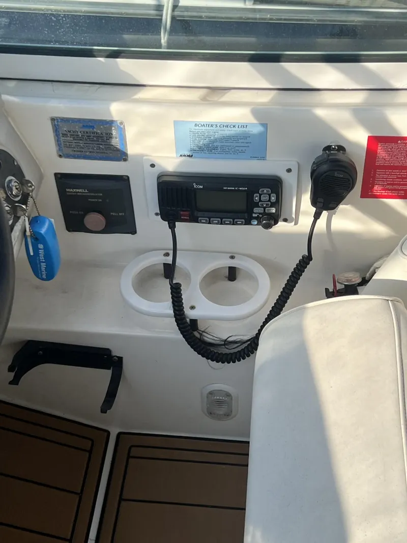 Slide: The Image of 2004 Cruisers Yachts 320 Express dashboard with radio and controls. - 8