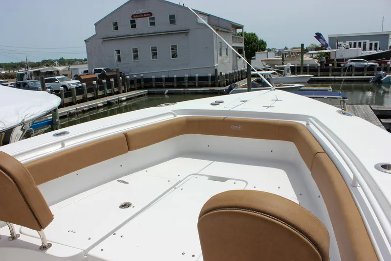 Slide: The Image of 2022 Sea Hunt Gamefish 27 Forward Seating boat at a marina dock. - 14