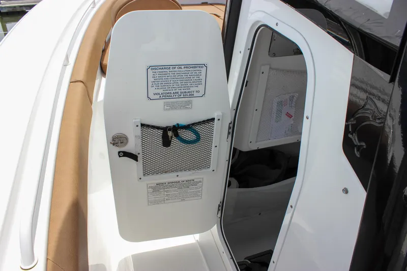 Slide: The Image of 2022 Sea Hunt Gamefish 27 Forward Seating boat interior with open storage compartment. - 19