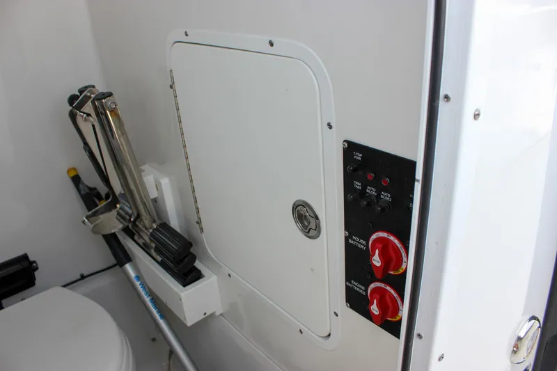 Slide: The Image of 2022 Sea Hunt Gamefish 27 Forward Seating boat interior with control panel and storage compartment. - 21