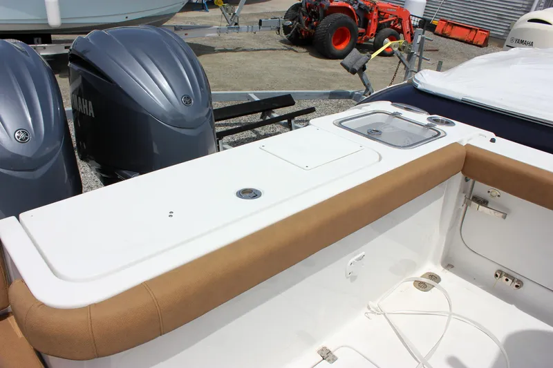 Slide: The Image of 2022 Sea Hunt Gamefish 27 Forward Seating boat with dual Yamaha engines and tan upholstery. - 24
