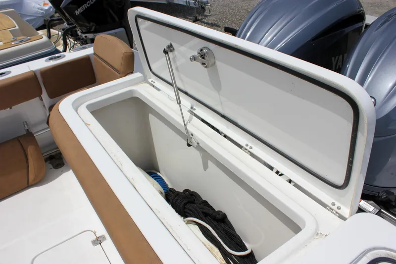 Slide: The Image of 2022 Sea Hunt Gamefish 27 Forward Seating storage compartment with open lid and visible ropes. - 25
